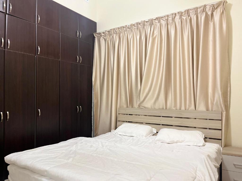 a bed with two white pillows in a bedroom at Jumeirah village circle in Dubai