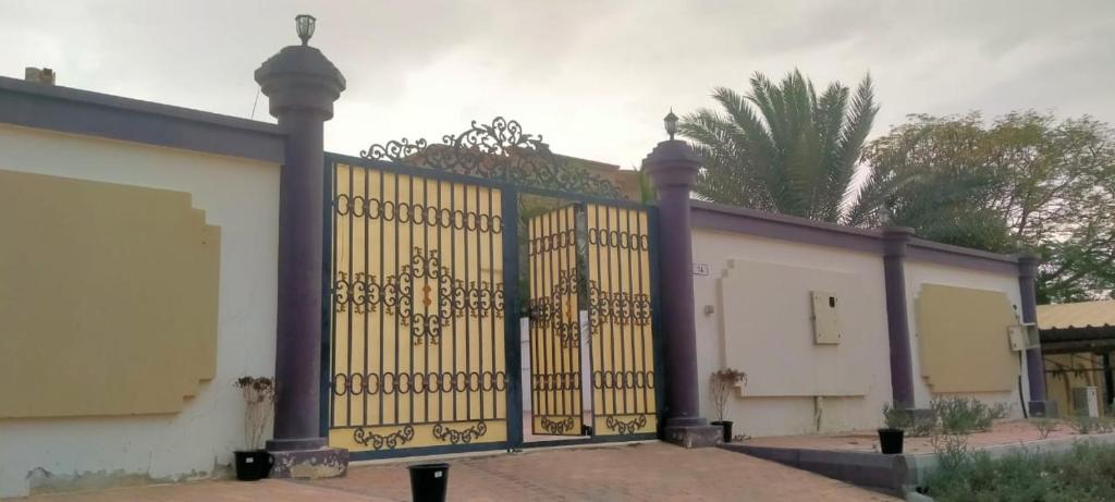 a gate to a building with a building at Al Dhait Residence in Ras al Khaimah