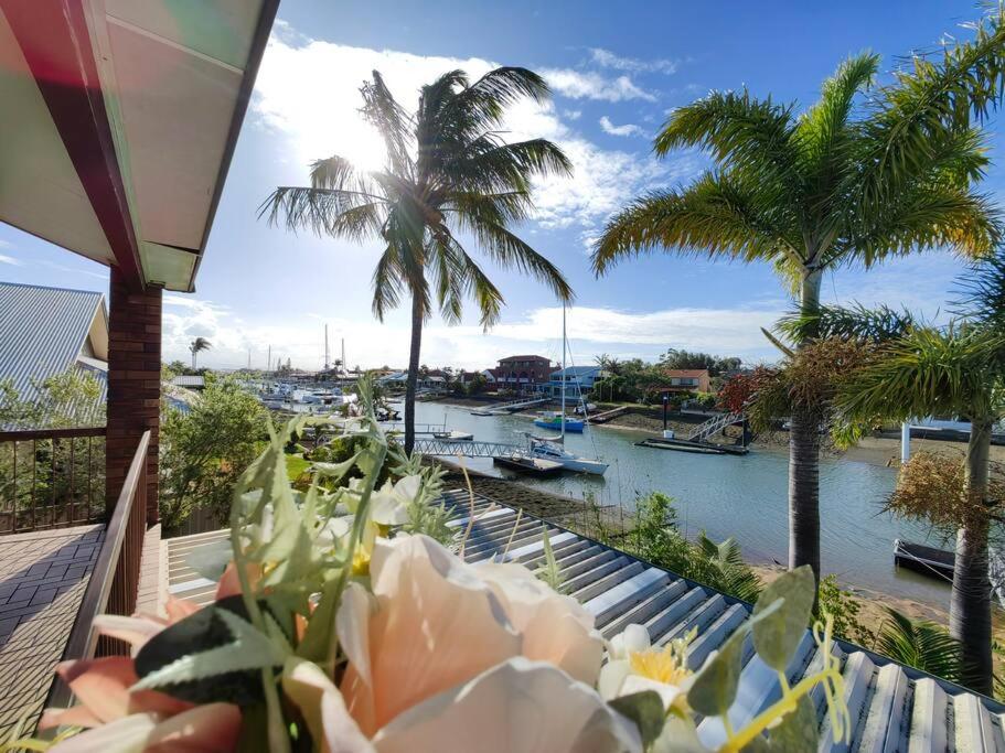 a view of a harbor with palm trees and a river at Canal view getaway in Newport in Scarborough