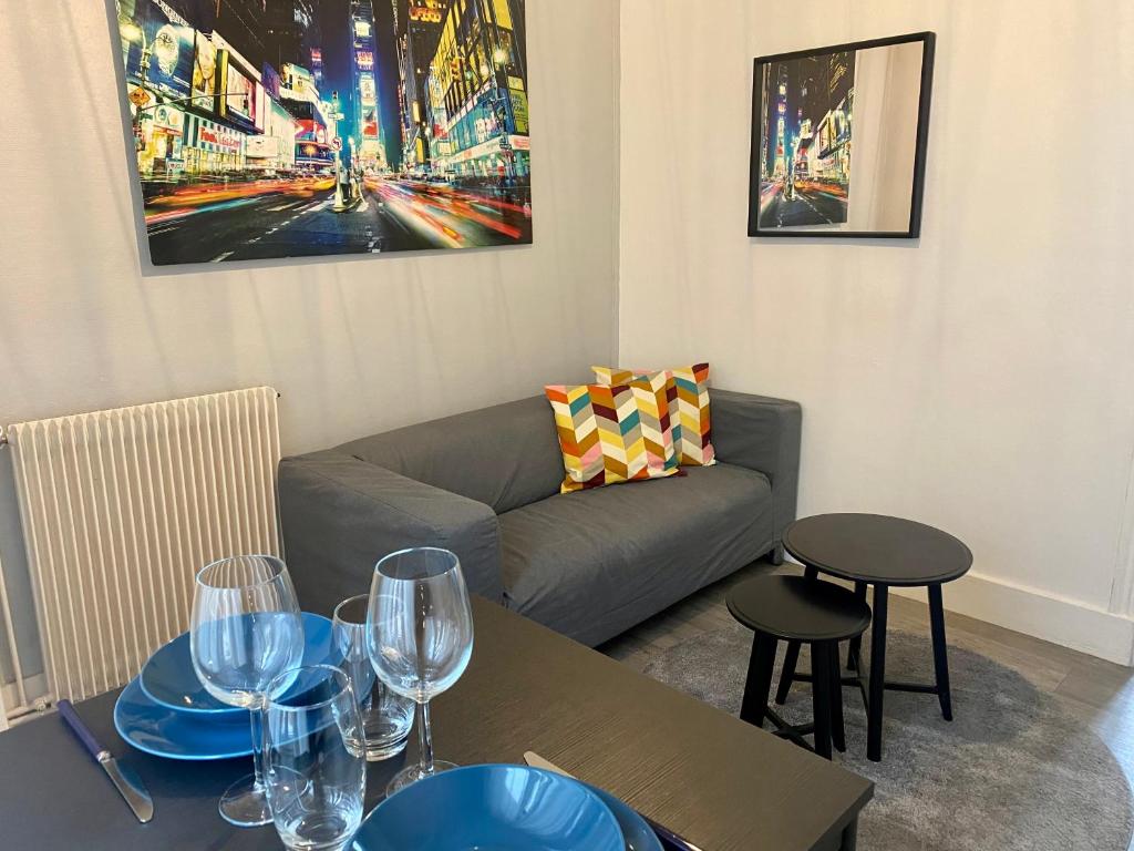 - un salon avec un canapé et des tables avec des verres à vin dans l'établissement Park Avenue, à Orléans