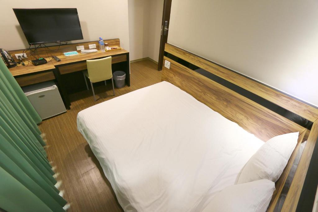 Voodi või voodid majutusasutuse 鼎立安商務旅館 Dinglian Hotel toas