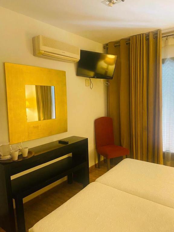 Postel nebo postele na pokoji v ubytování Hostal Tres Soles
