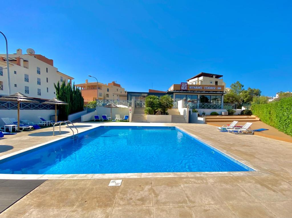 a large swimming pool in the middle of a building at Sunny and Bright Corcovada, T1 with Large Terrace, Albufeira in Albufeira