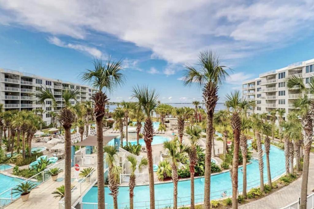 an aerial view of a resort pool with palm trees at DW-Sandpiper 407-Resort Style Condo w/ Great Views in Fort Walton Beach