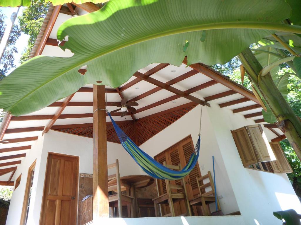 a hammock in the front of a house at Finca Ardilla Jungle Lodge in Cocles