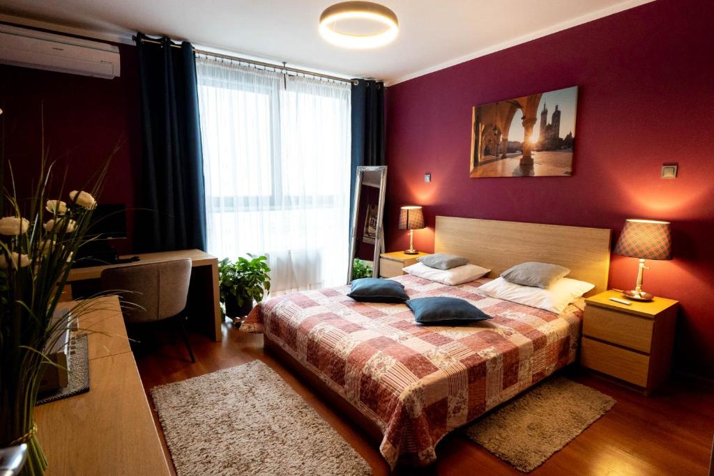 a bedroom with a bed with two pillows on it at Torre Verona Apartment - 70m2, Terrace in Kraków