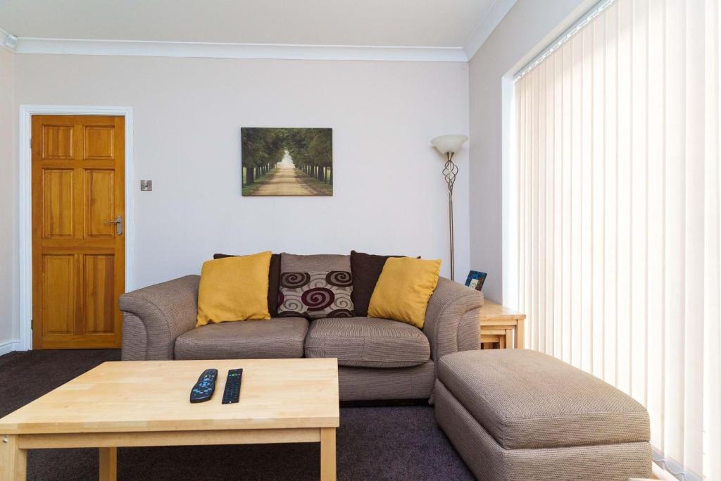 a living room with a couch and a coffee table at OAKWOOD HOUSE Detached home in South Leeds in Leeds