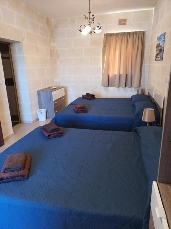 Postel nebo postele na pokoji v ubytování Ta Wigi Farmhouse