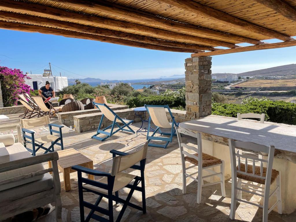 a table and chairs on a patio with a view at villa ZEUS - PARIKIA - PAROS - GRECE in Krotiri