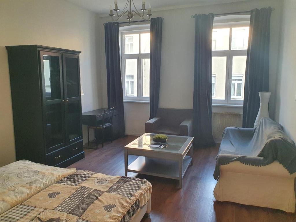 ein Schlafzimmer mit einem Bett, einem Stuhl und einem Tisch in der Unterkunft Spacious Apartment near the center in Wien