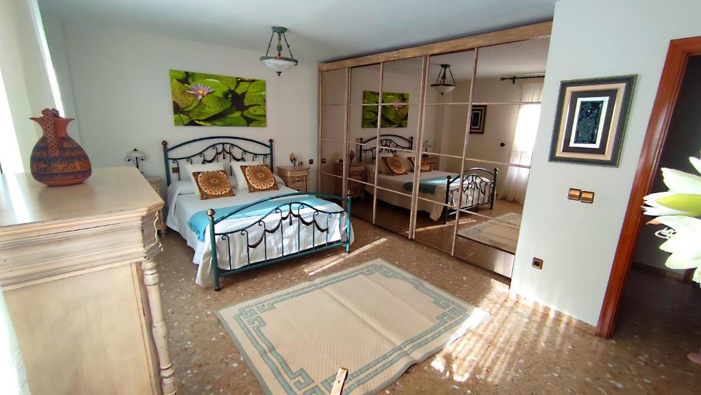 a bedroom with a bed and a mirror at Alcazaba in Torre del Mar