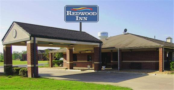 a redwood inn sign in front of a building at Redwood Inn - White Hall in White Hall