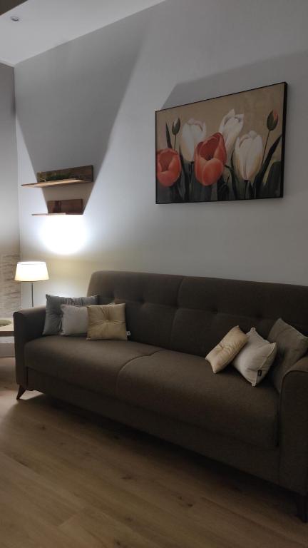 a couch in a living room with a painting on the wall at Marina Apartments in Catanzaro Lido