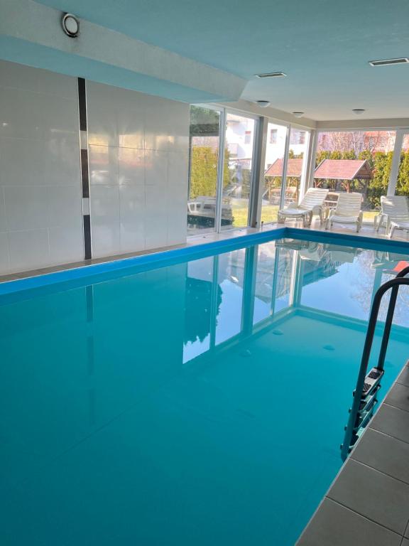 a large swimming pool with blue water at Wellness Dorina in Siófok
