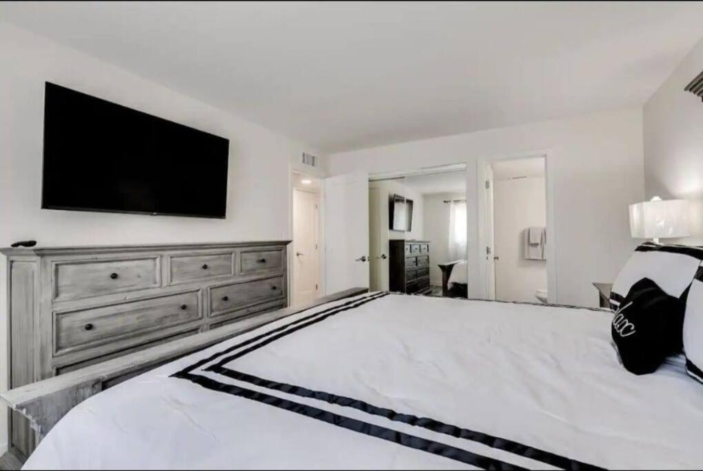 a bedroom with a large bed with a television on the wall at Modern Villa in Old Litchfield in Litchfield Park