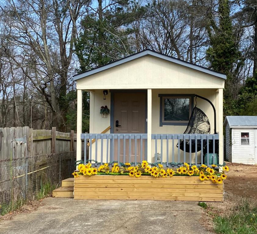 a small house with a bunch of sunflowers on it at Your Own Cozy Tiny Home in Austell
