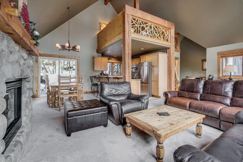 a living room with leather furniture and a fireplace at Cabin In The Pines 4 in Keystone
