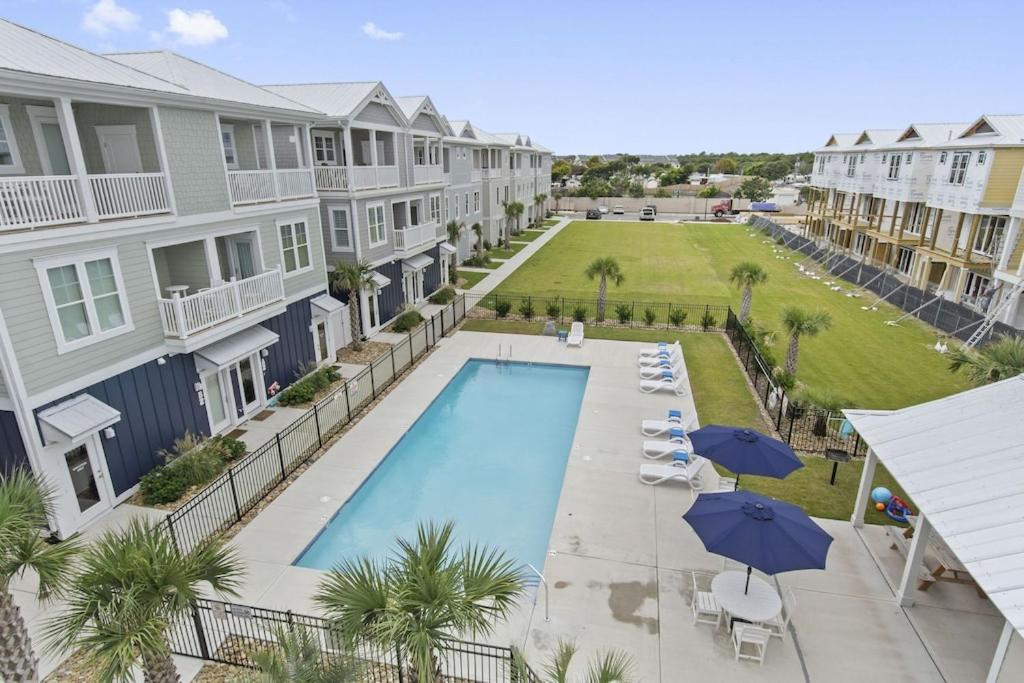 an aerial view of a pool at a resort with umbrellas at Isle of Dreams in Emerald Isle