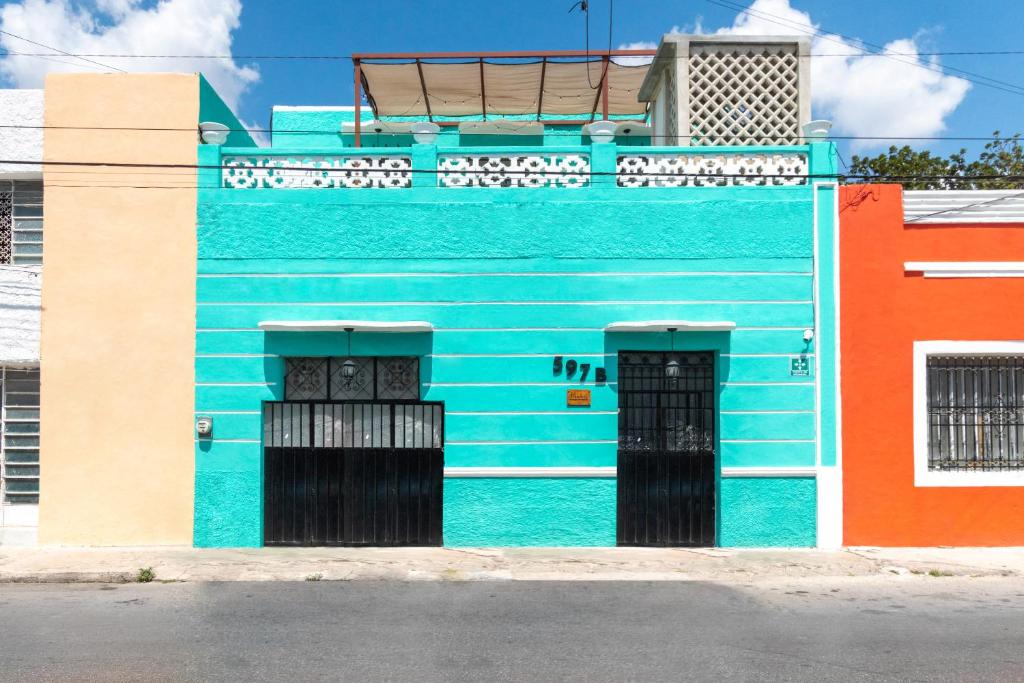 a blue building with two doors on a street at Mérida 62 in Mérida