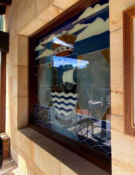 a glass window on the side of a building at El Tejo de Comillas in Comillas