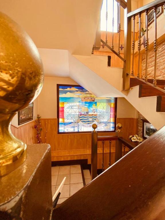 a staircase with a stained glass window in a building at El Tejo de Comillas in Comillas