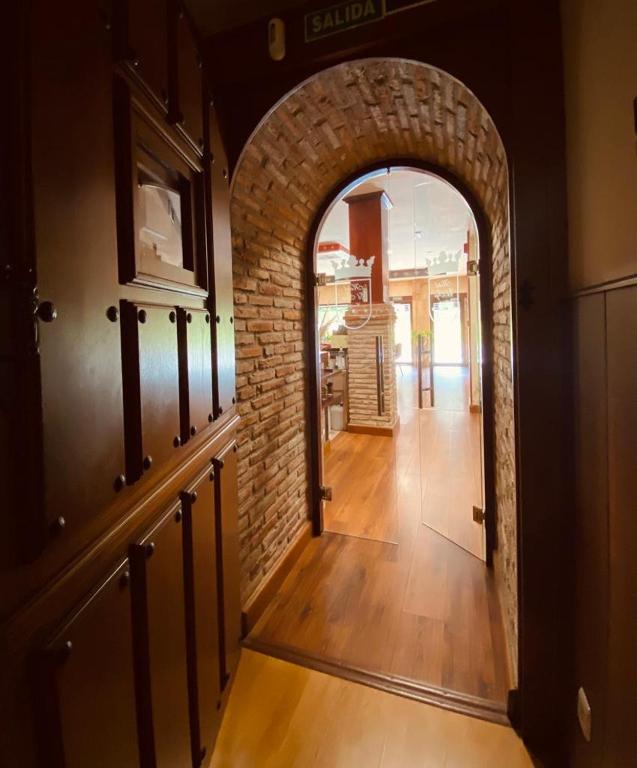 an arched hallway with an archway in a house at El Tejo de Comillas in Comillas
