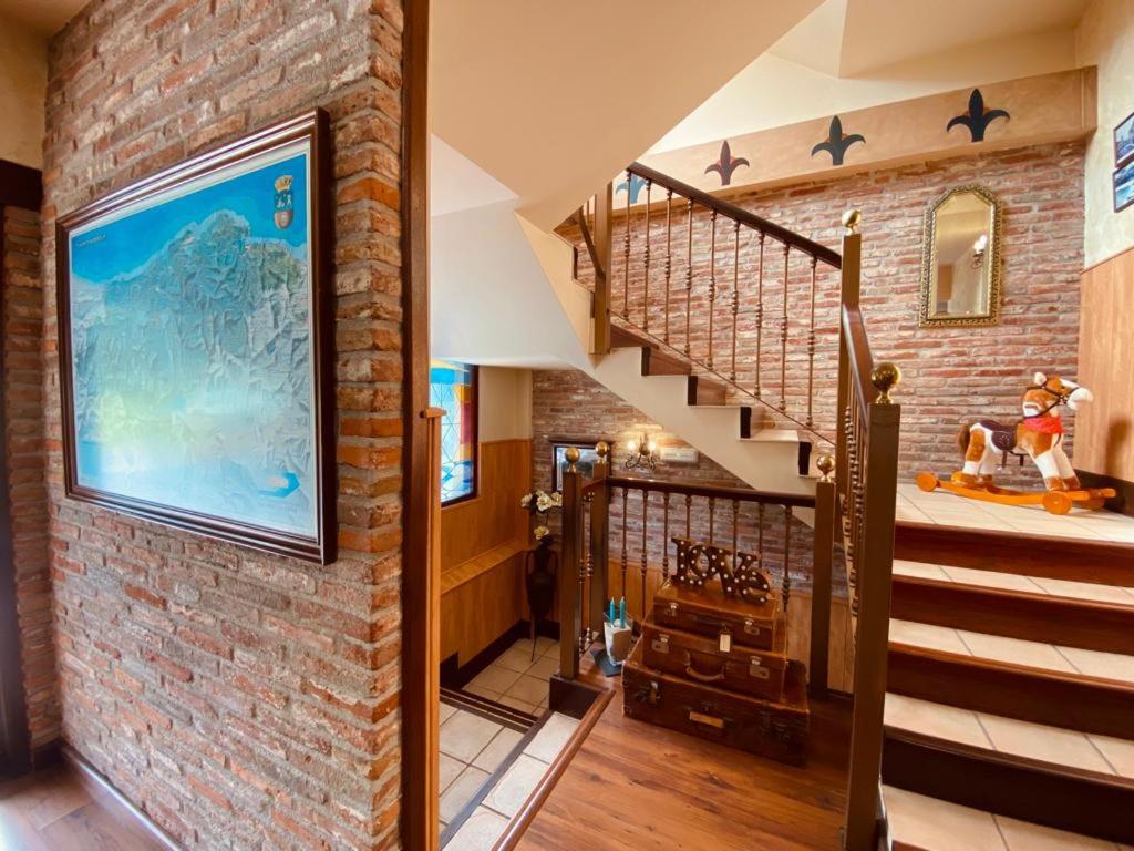 a brick wall with a staircase in a house at El Tejo de Comillas in Comillas
