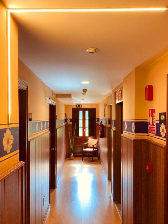 a hallway of a home with yellow walls and wooden floors at El Tejo de Comillas in Comillas