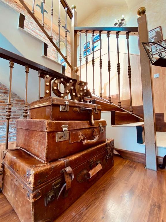 a stack of suitcases sitting under a staircase at El Tejo de Comillas in Comillas
