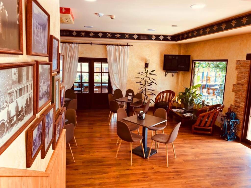 a dining room with tables and chairs in a room at El Tejo de Comillas in Comillas