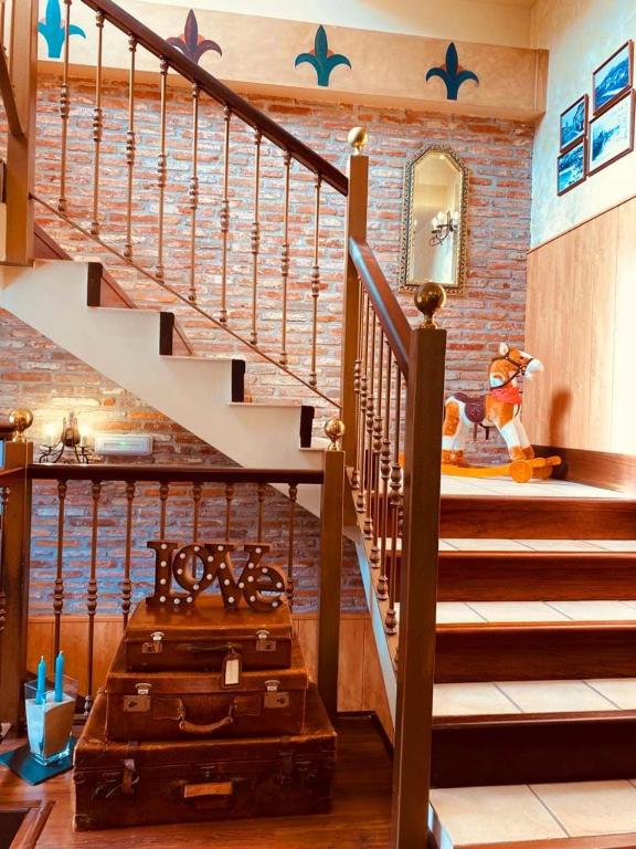 a room with a staircase with a suitcase at El Tejo de Comillas in Comillas