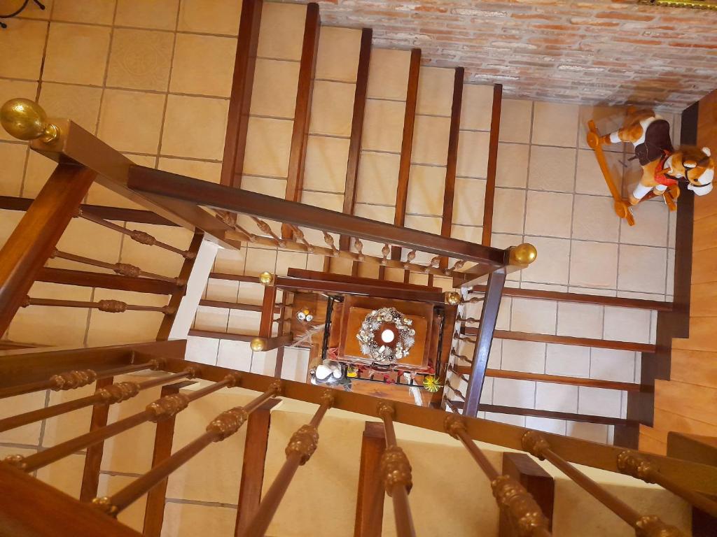 an overhead view of a stairs with a clock at El Tejo de Comillas in Comillas