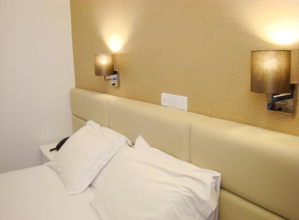 Postel nebo postele na pokoji v ubytování Seculo Hotel