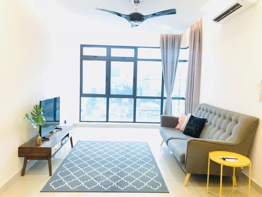 a living room with a couch and a large window at Selayang 18 Residences (100mbps Wifi & Netflix) in Batu Caves