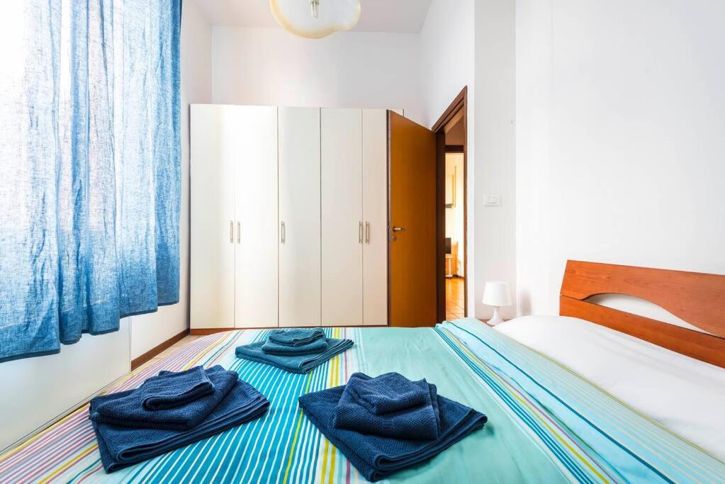 - une chambre avec un lit et des serviettes bleues dans l'établissement Apartment BOLOGNA City Center TRAIN STATION, à Bologne