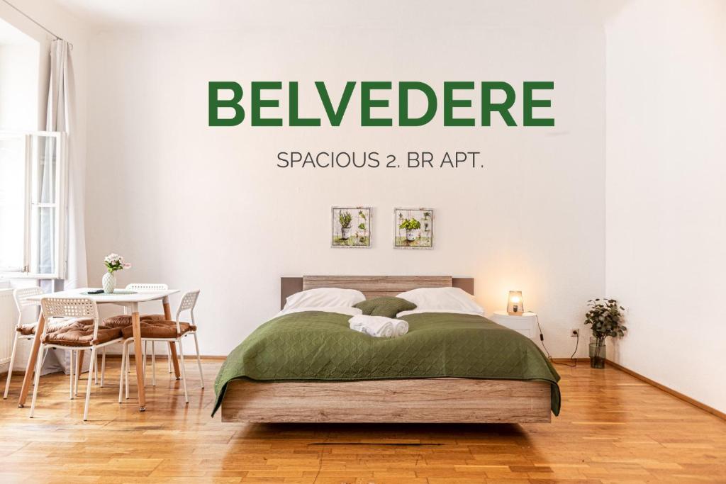 a bedroom with a bed with a green sign on the wall at Smart 2BR Apt. Perfect for Longstays near Rennweg in Vienna
