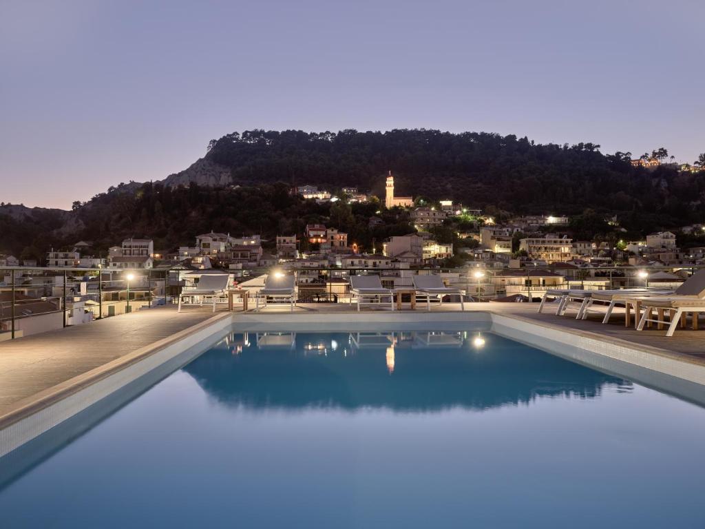 a large swimming pool with a view of a city at Strada Marina Hotel in Zakynthos