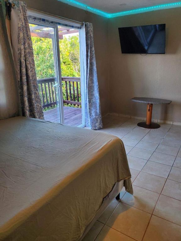 a bedroom with a bed and a view of a balcony at StarFish Apartment in Six Huts