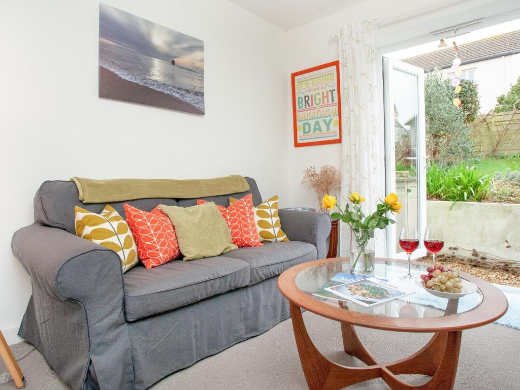 a living room with a couch and a table at Malborough Park in Malborough