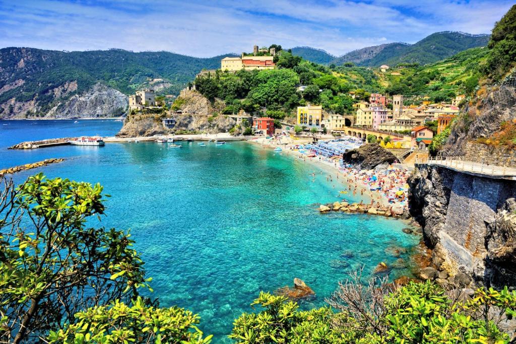 a beach with a group of people in the water at Casa Natalina in Monterosso al Mare