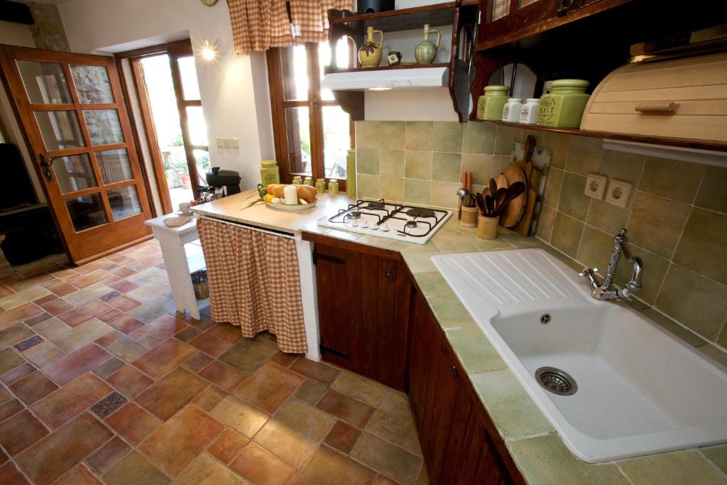 a kitchen with a sink and a stove at Villa Moro House in Milna