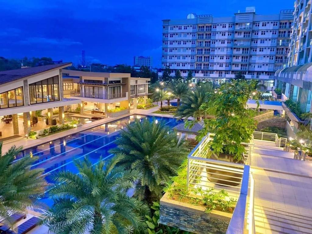 an overhead view of a building with a swimming pool at night at COZY PLACE TO RELAX VERDON PARC in Davao City