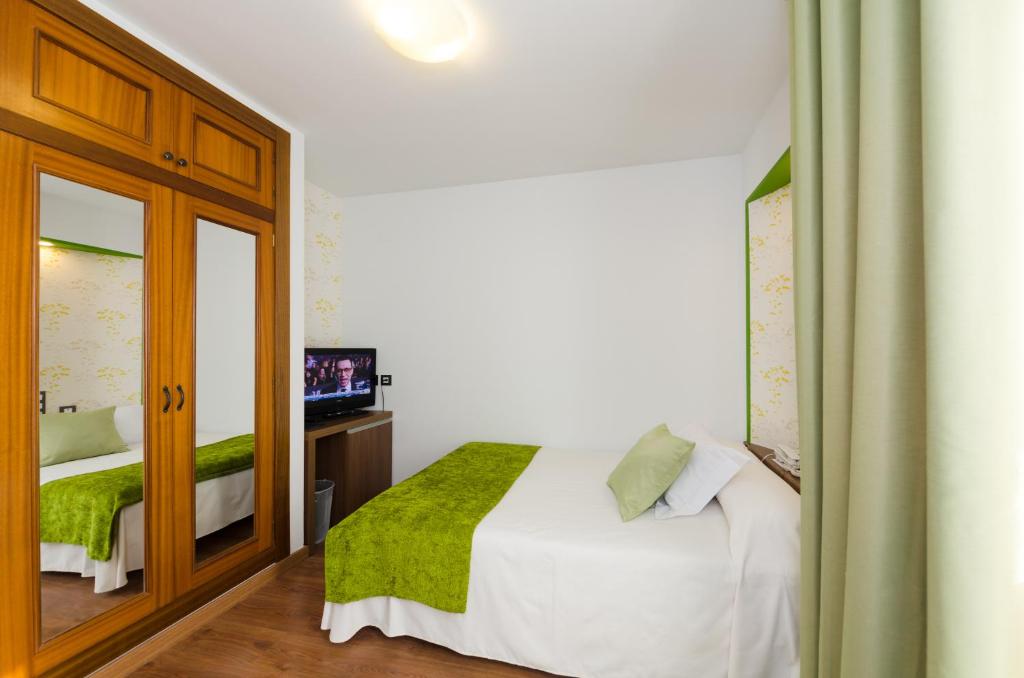 Postel nebo postele na pokoji v ubytování Hotel Apolo