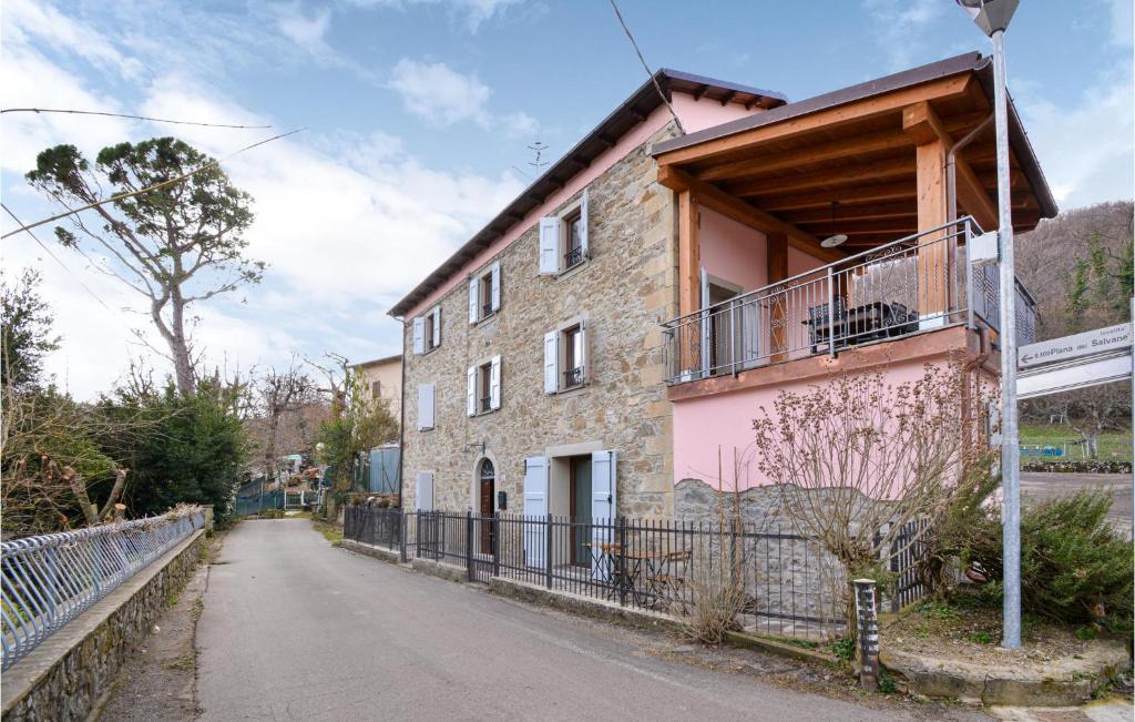 a brick building with a balcony on a street at Awesome Home In Burzanella With Wifi And 4 Bedrooms 