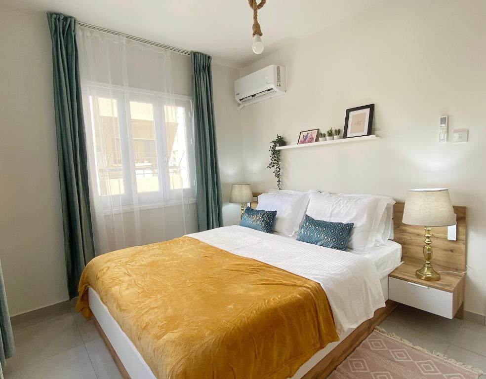 a bedroom with a large bed with a yellow blanket at Peaceful 2 bedroom Flat in Engomi