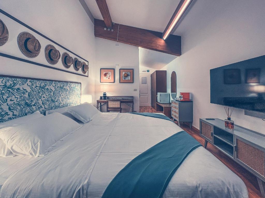 Postel nebo postele na pokoji v ubytování Club del Sole Tenuta Primero Hotel