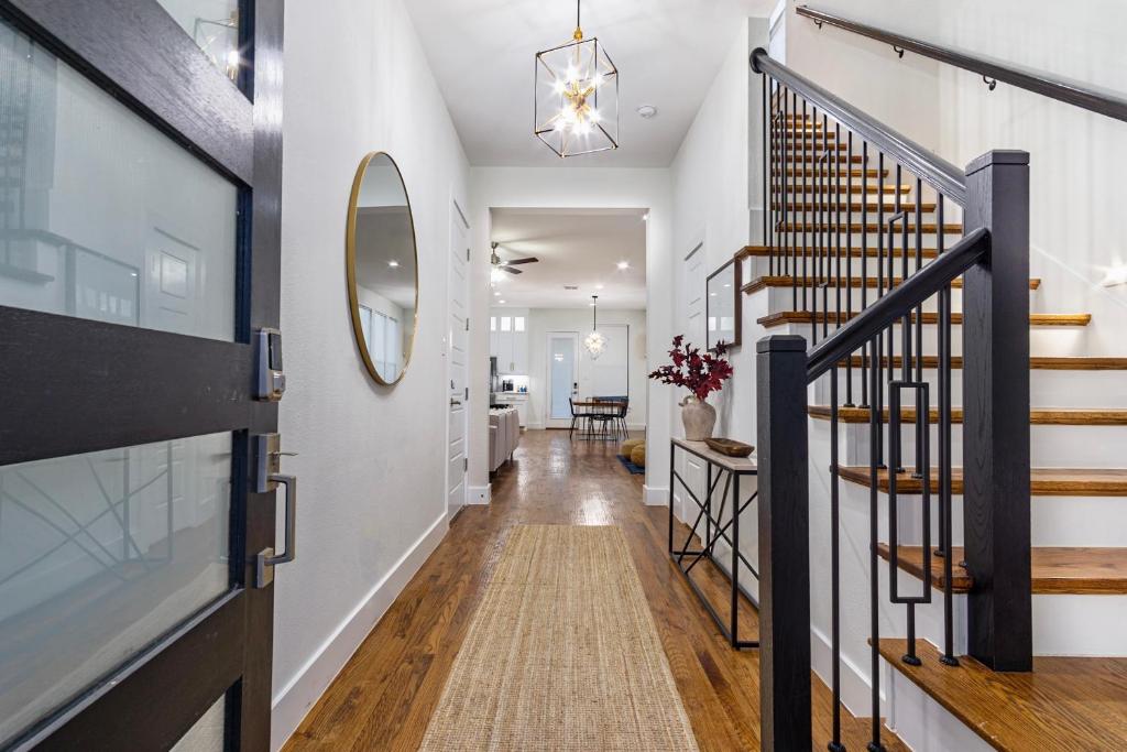 a hallway with a staircase and a mirror at Beautiful Contemporary 4BR near Downtown Dallas in Dallas