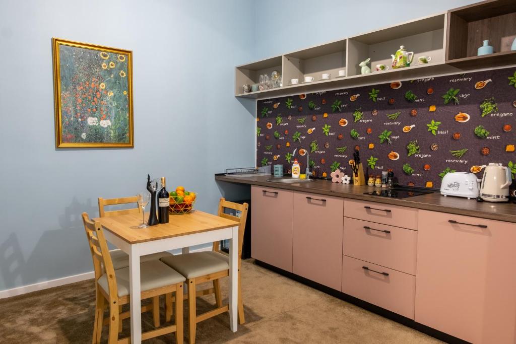 a kitchen with a table and a counter top at City Life Timisoara in Timişoara