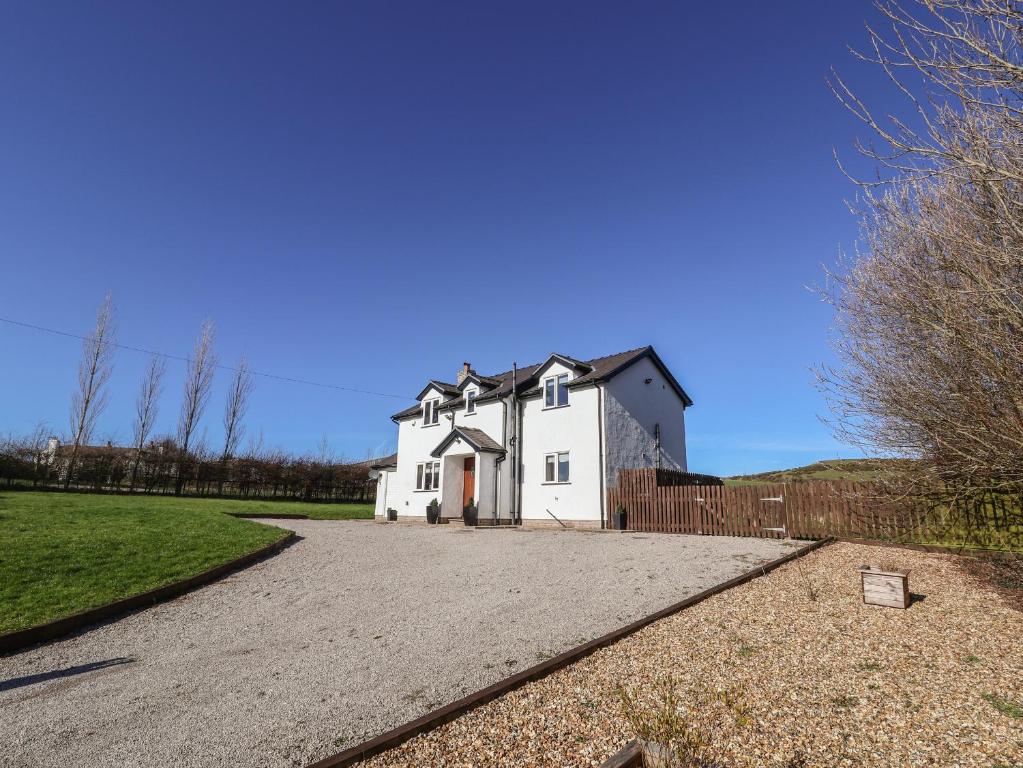 a white house with a fence and a driveway at Maes Yr Haf in Rhyl