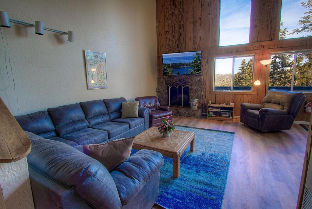 a living room with a blue couch and a fireplace at Life's Better The Milky Way condo in Stateline